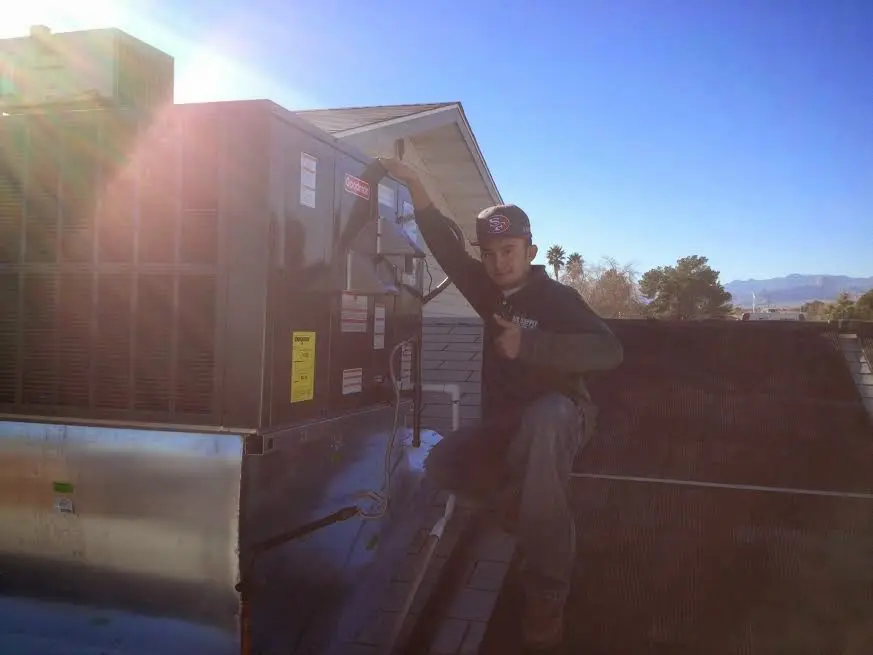 HVAC technician performing AC Tune-Up on a rooftop unit in Placerville
