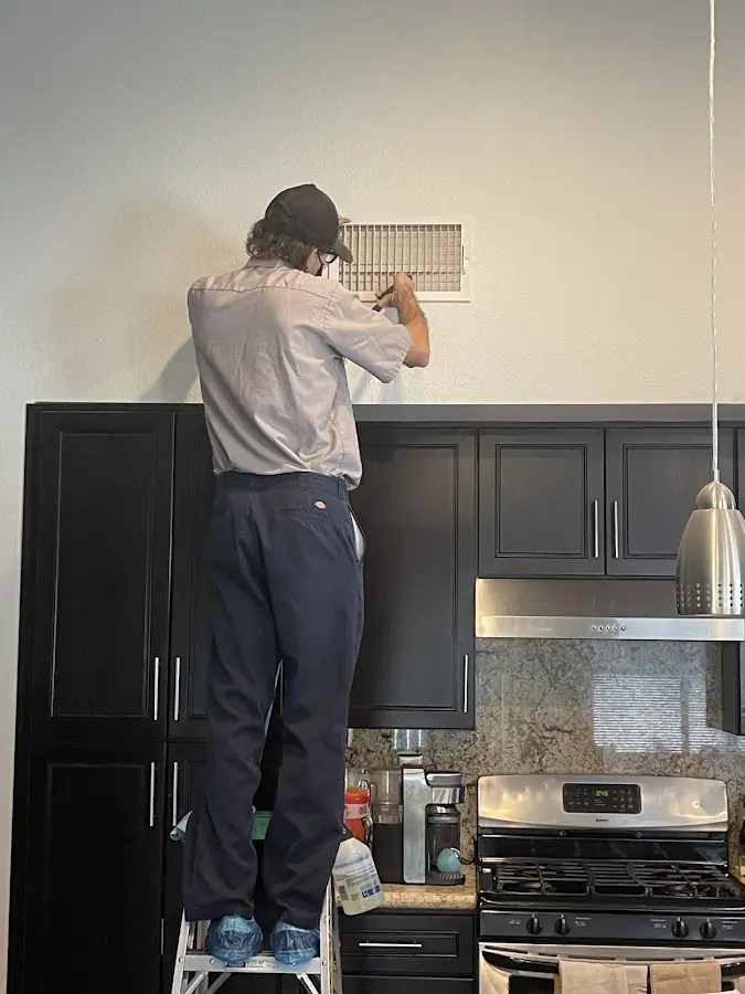 Technician inspecting an air vent during HVAC service in Placerville